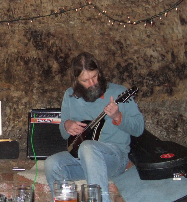 Singer songwriter Alan Robinson playing mandolin  at the Loggerheads Nottingham